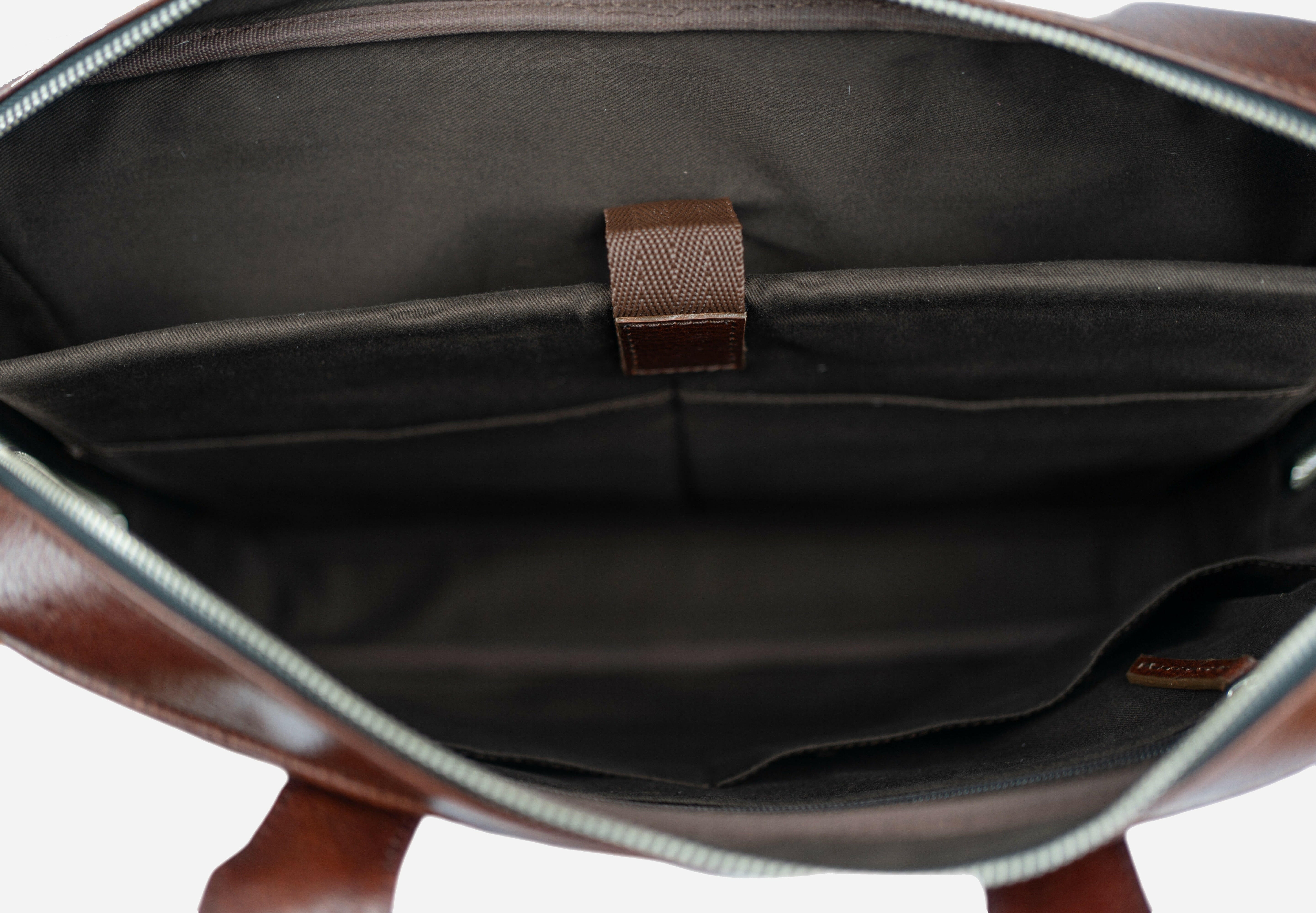 Burgunddy  leather bag with a strap on a white background